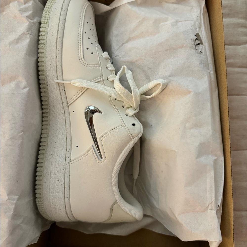Nike White Shoes with Metallic Silver Accent